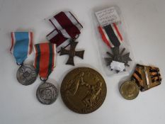 Five 20th century copy medals with ribbons together with a circular brass plaque
