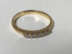An 18ct gold five stone diamond ring, approximately 0.25ct, size N, 3g.