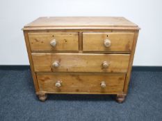 An antique pine four drawer chest