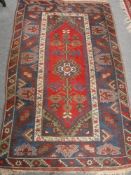 A Persian rug on blue and red ground