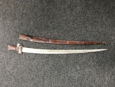 An Eastern leather handled sword in scabbard