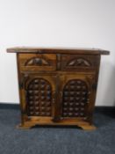 A rustic pine cabinet fitted two drawers