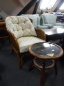 A bamboo and wicker conservatory armchair together with a circular glass topped coffee table