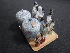 A pair of oriental style lidded vases with flower decoration,