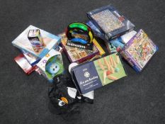 A box of assorted jigsaws and games