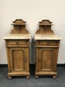 A pair of French inlaid walnut marble topped bedside cabinets,