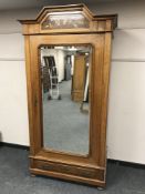 A French inlaid walnut mirror door wardrobe, fitted with a drawer,