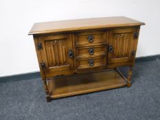 An oak linen fold side cabinet