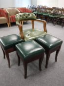 A green button leather armchair and three leather upholstered bar stools