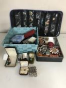 A basket and tin containing an assortment of costume jewellery