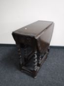 A carved oak gate leg table