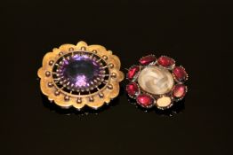 A Victorian amethyst brooch together with a garnet memorial brooch