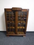 An early 20th century oak glazed door bookcase CONDITION REPORT: Some watermarks to