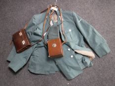 Four military uniforms and three leather cameras cases