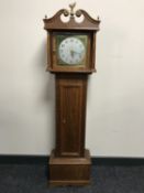 A late 20th century oak granddaughter clock with battery movement and brass dial