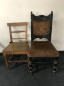 An antique kitchen chair and an antique carved oak dining chair