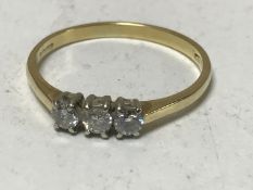 An 18ct gold three stone diamond ring
