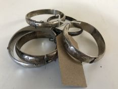 Five silver / white metal bangles.