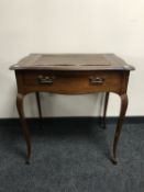 An Edwardian mahogany writing table fitted a drawer