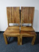 A pair of mango wood dining chairs