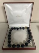 A large blue agate necklace with gold clasp,