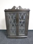 An oak wall mounted corner display cabinet