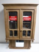 An Edwardian oak wall mounted smoker's cabinet bearing 