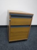 A two drawer beech effect under-desk chest