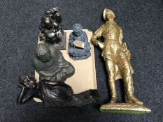 A large chalk painted figure of a cavalier and four Buddha figures