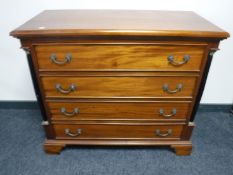 A reproduction mahogany chest on bracket feet