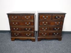 A pair of Regency style five drawer chests