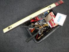 A crate containing a large quantity of assorted hand tools and power tools together with two spirit