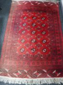 A Kashan rug on red ground