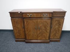 An inlaid mahogany Regency style four door break front sideboard