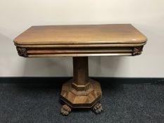 A William IV mahogany pedestal foldover tea table on paw feet
