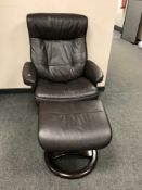 A brown leather relaxer chair with footstool retailed by John Lewis