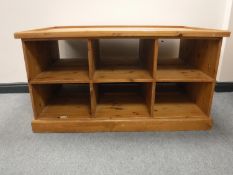 A pine play table fitted drawers beneath
