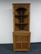An oak corner display cabinet