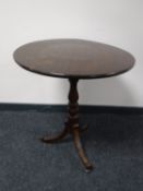 A Victorian oak tilt top pedestal wine table