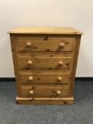 A pine four drawer chest,