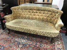 A Victorian mahogany button back settee,