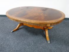 An oval inlaid mahogany coffee table