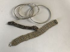 Five silver / white metal bangles.