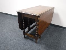 An oak pie crust edge gate leg table