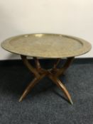 A folding Eastern brass topped table