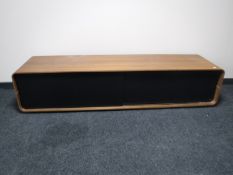 An entertainment stand with sliding doors in a teak finish