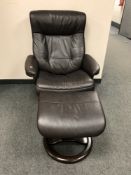A brown leather relaxer chair with footstool retailed by John Lewis