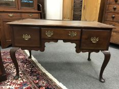 A Georgian style mahogany desk fitted with three drawers,