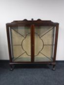 An early 20th century display cabinet on claw and ball feet