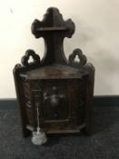 A continental oak corner wall shelf with carved panel door depicting a pheasant